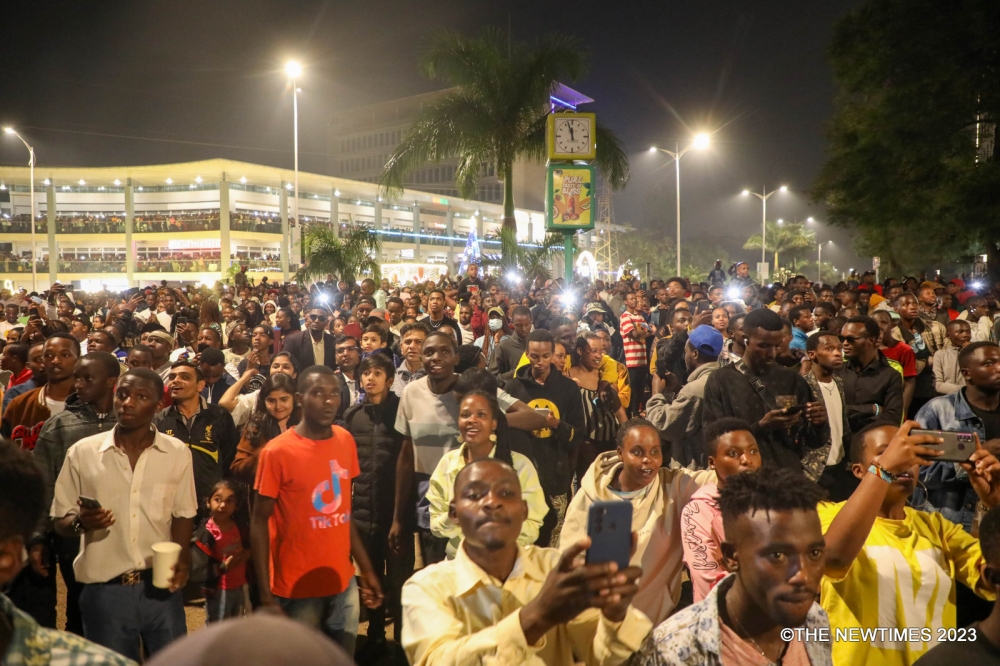 Kigali residents take photos of fireworks as Rwandans ushered in the New Year in 2023. Financial experts have shared tips on being frugal during the festive season. Photo: Craish Bahizi