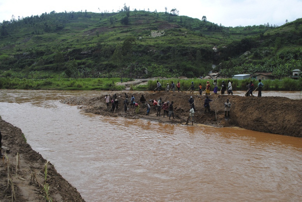 Residents clear mud and sand from Giciye River in Ngororero District after heavy rainfall. Photo: File.