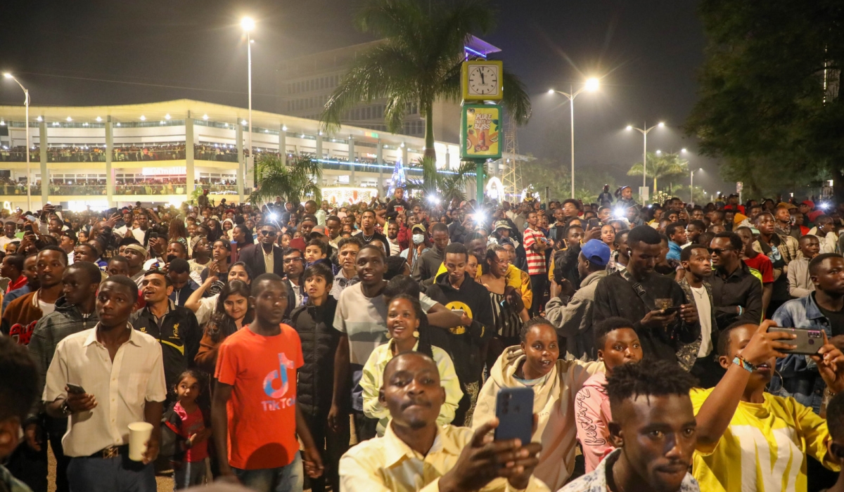 Kigali residents take photos of fireworks as Rwandans ushered in the New Year in 2023. Financial experts have shared tips on being frugal during the festive season. Photo: Craish Bahizi