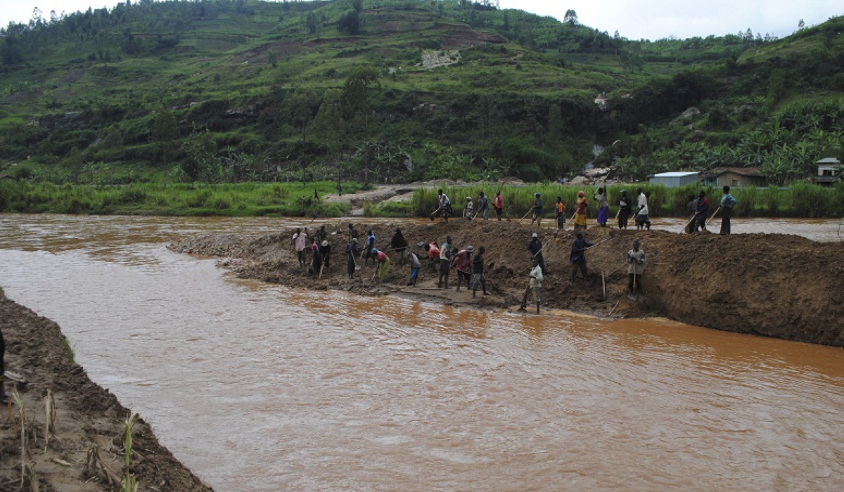 Residents clear mud and sand from Giciye River in Ngororero District after heavy rainfall. Photo: File.