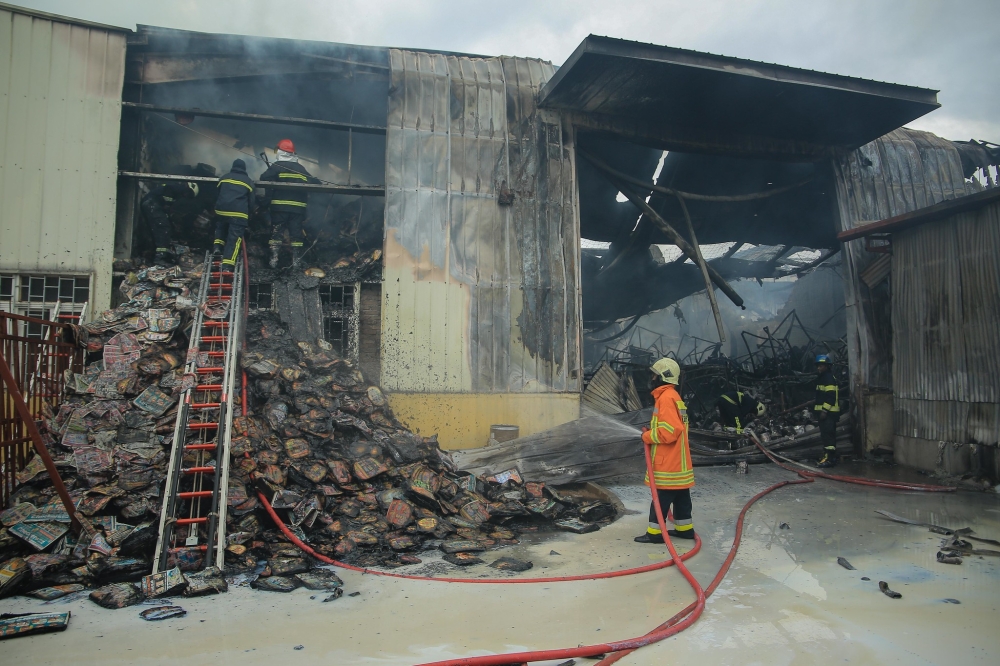 Fire fighters on duty as fire engulfed SIGMA Industries LTD in the Kigali Special Economic Zone i on November 26, 2021. File