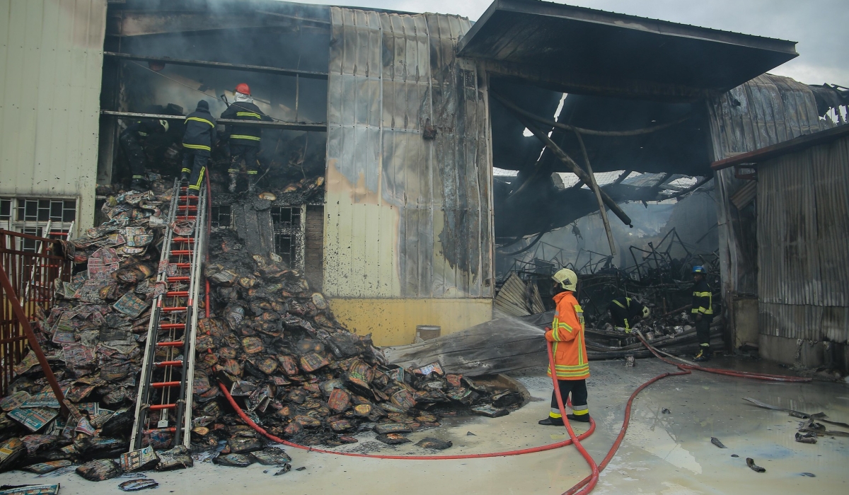 Fire fighters on duty as fire engulfed SIGMA Industries LTD in the Kigali Special Economic Zone i on November 26, 2021. File