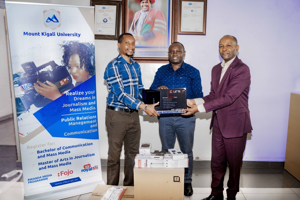 Festus Irungu hands over equipment to Dr. Martin Mimemia (Left) as the Board of trustees Representative, Antony Kamau looks on, at Mount Kigali University campus. Courtesy