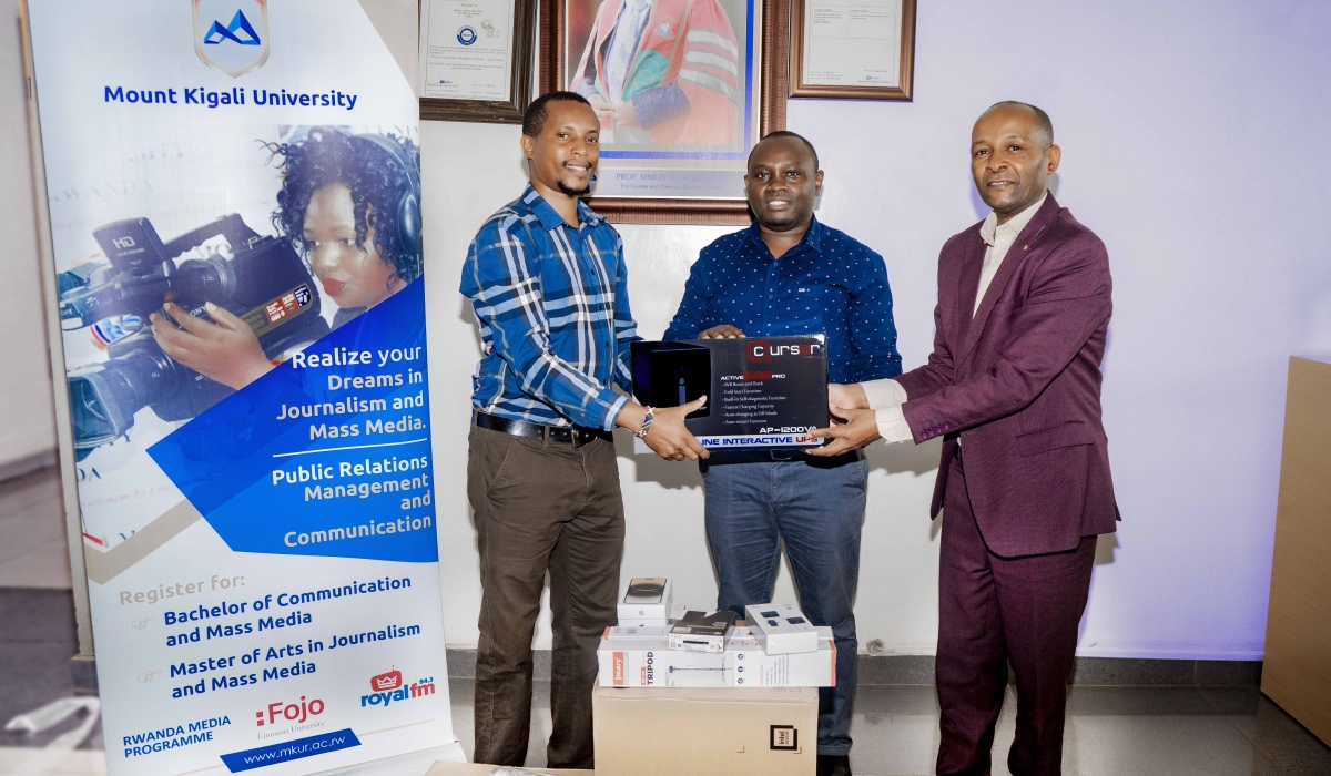 Festus Irungu hands over equipment to Dr. Martin Kimemia (Left) as the Board of trustees Representative, Antony Kamau looks on, at Mount Kigali University campus. Courtesy