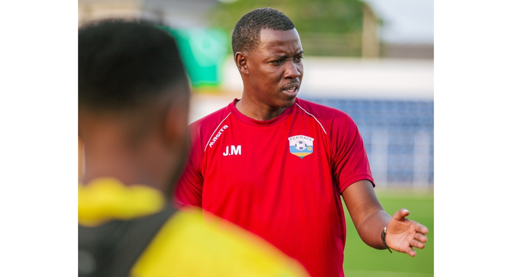 Amavubi interim coach Jimmy Mulisa gives instructions to the players during a training session. Courtesy