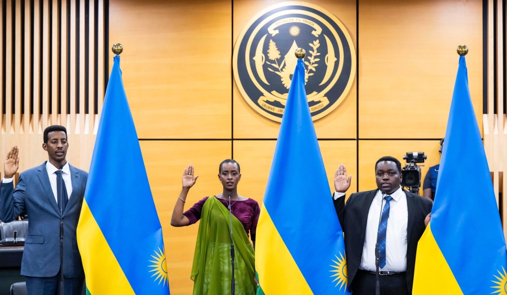 (L-R)  Rwego Ngarambe, the Minister of State in the Ministry of Sports, Nelly Mukazayire, the new Minister of Sports, and Godfrey Kabera, Minister of State in charge of the National Treasury take oath of office.