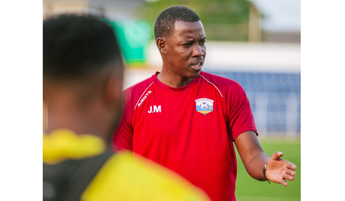 Amavubi interim coach Jimmy Mulisa gives instructions to the players during a training session. Courtesy