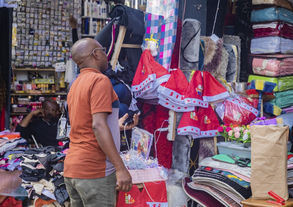 A client shopping some items for fstive season at Kigali Business District in Nyarugenge. Photo by Craish Bahizi