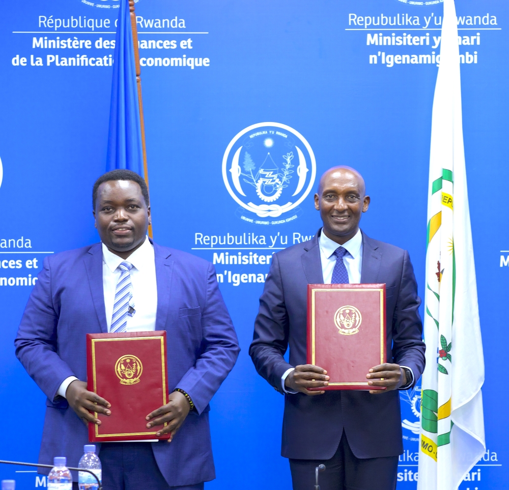 The newly appointed minister of state, Godfrey Kabera (L) with  the outgoing Minister of State for National Treasury, Richard Tusabe during the handover on Tuesday, December 24. Courtesy