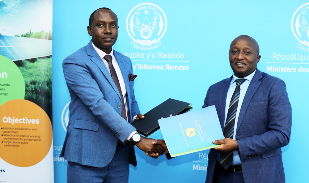 Chief Executive Officer of EPD Serge Wilson Muhizi and Fidele Abimana, PS at MININFRA exchange documents at the  signing event on December 23, 2024.