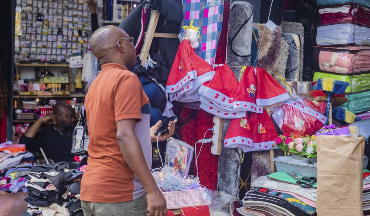 A client shopping some items for fstive season at Kigali Business District in Nyarugenge. Photo by Craish Bahizi