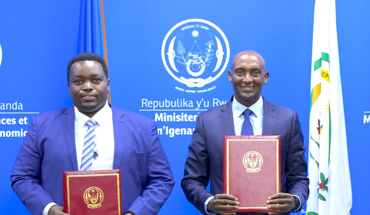 The newly appointed minister of state, Godfrey Kabera (L) with  the outgoing Minister of State for National Treasury, Richard Tusabe during the handover on Tuesday, December 24. Courtesy