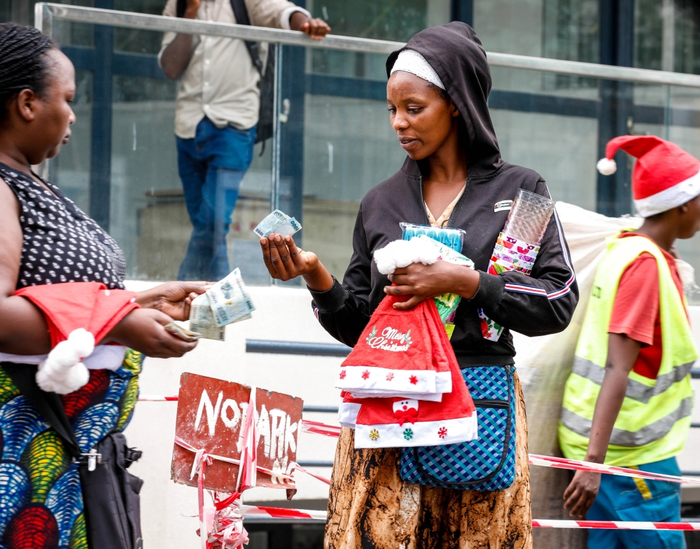 A woman buys some items for  christmas celebrations at Kigali&#039;s central  Business District on Christmas Eve on December 24. Photo by Craish Bahizi