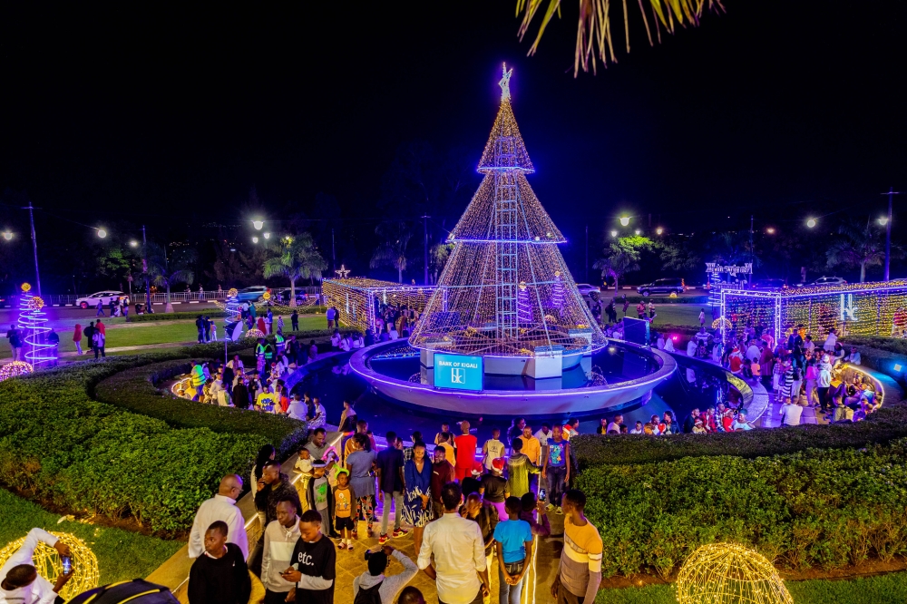 Children and parents at the City&#039;s main roundabout take pictures on Christmas Eve. Decoration lights are also illuminating some of the city’s high rise buildings. All photos by Craish Bahizi