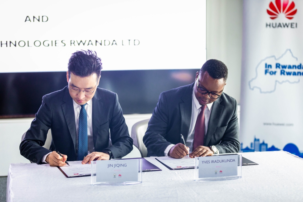 Yves Iradukunda, the Permanent Secretary of the Ministry of ICT and Innovation, and  Jin Jinqing, the Managing Director of Huawei Technologies Rwanda LTD sign the agreement on Friday, December 20. Craish Bahizi