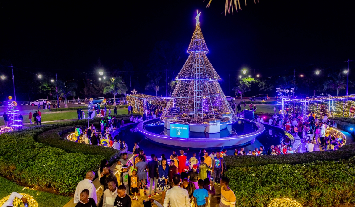 Children and parents at the City&#039;s main roundabout take pictures on Christmas Eve. Decoration lights are also illuminating some of the city’s high rise buildings. All photos by Craish Bahizi