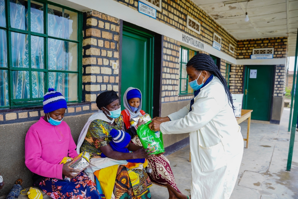 Parents in Nyamagabe receive packages of nutritious flour to support their babies in the fight against stunting. Photo by Craish Bahizi