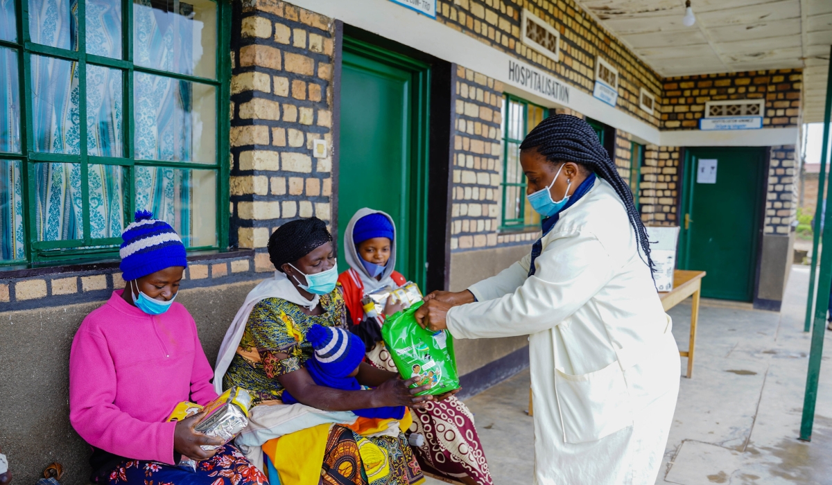 Parents in Nyamagabe receive packages of nutritious flour to support their babies in the fight against stunting. Photo by Craish Bahizi