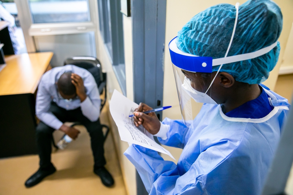 A medic records a patient&#039;s identification details during a medical drill focused on pandemic preparedness at King Faisal Hospital in 2022 . Photo by Olivier Mugwiza