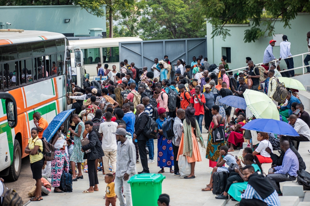 Passengers board buses on their way to join their families upcountry for the New Year celebration, on Tuesday, December 31. Photos by Dan Gatsinzi