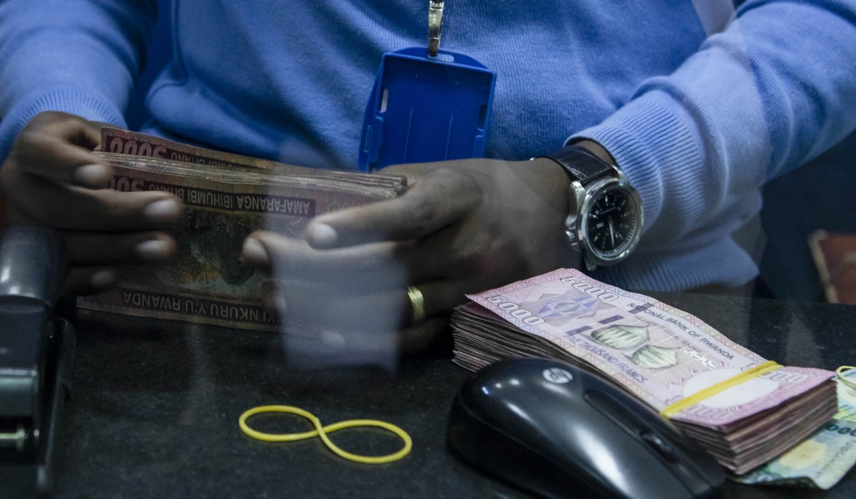 A teller attends to clients at Bank of Kigali main branch. File