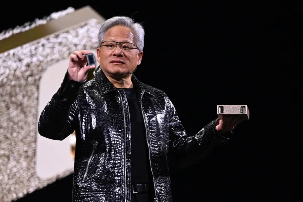 Nvidia CEO Jensen Huang holding the Project Digits computer onstage at CES 2025.