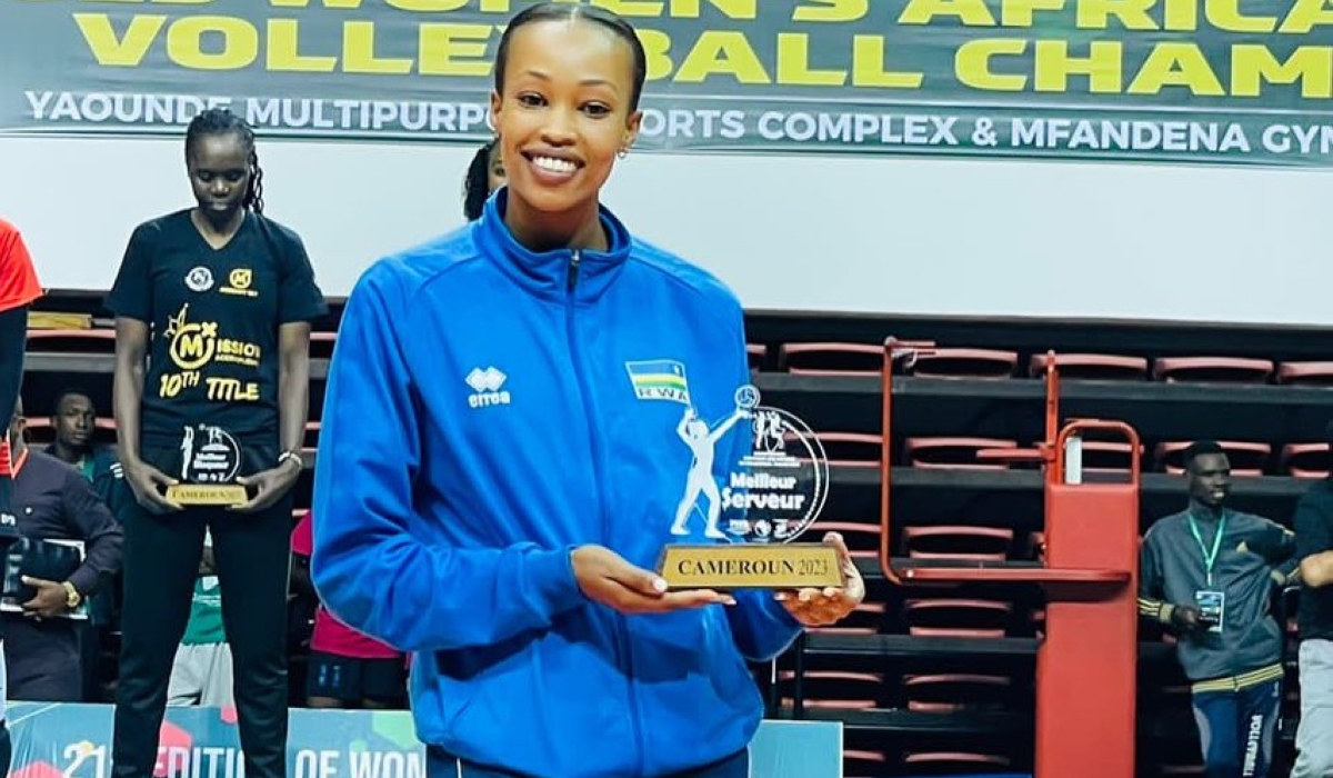 Valentine Munezero holding a trophy of being the best opposite hitter in 2023 African Championship