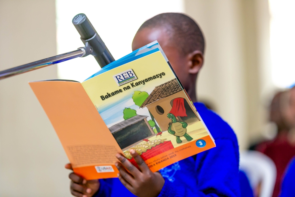 A student reads a books during a reading competition dubbed Mumpe Akanya Nsome at Group Scolaire Camp Kigali. Craish BAHIZI