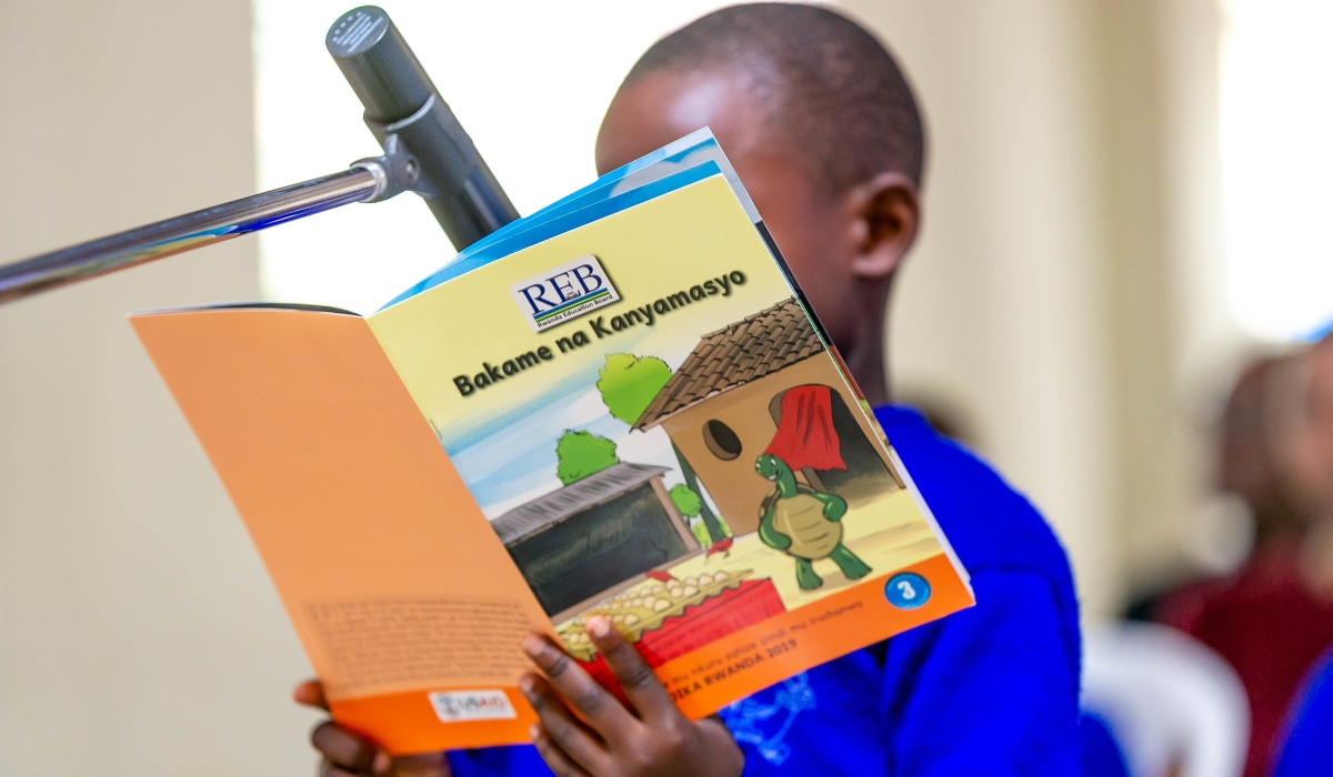 A student reads a books during a reading competition dubbed Mumpe Akanya Nsome at Group Scolaire Camp Kigali. Craish BAHIZI