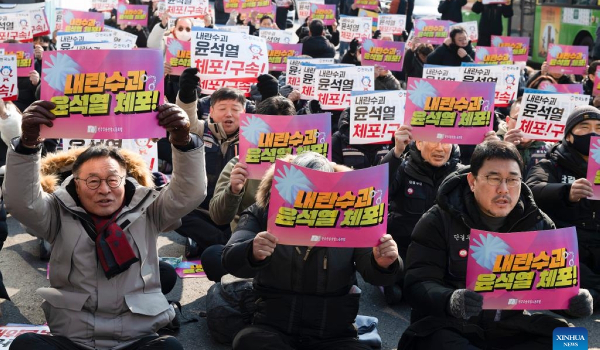 Protesters in favor of the impeachment of South Korean President Yoon Suk-yeol shout slogans "Immediate Arrest" during a rally near the presidential residence in Seoul, South Korea, Jan. 12, 2025. South Korean President Yoon Suk-yeol will not attend the first hearing of his impeachment trial, scheduled for Tuesday, for safety concerns, Yoon&#039;s defense counsel said Sunday. (Photo by Jun Hyosang/Xinhua)