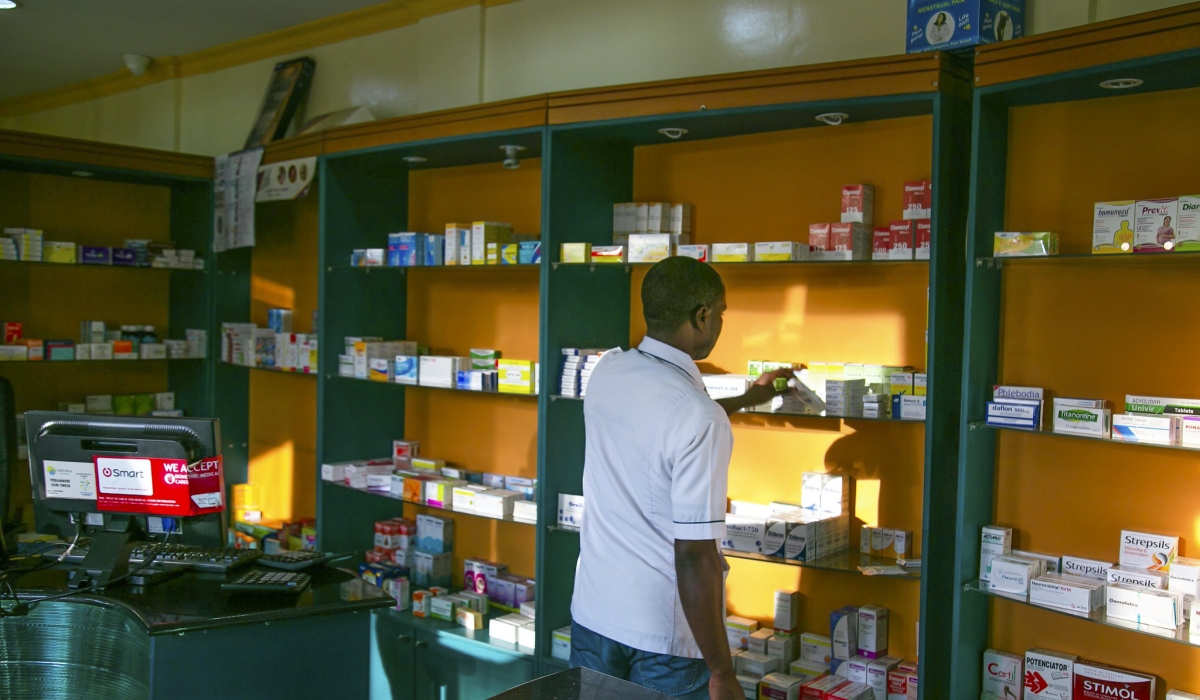 A pharmacist looks for drugs at Kisimenti in Kigali.Photo by Craish Bahizi