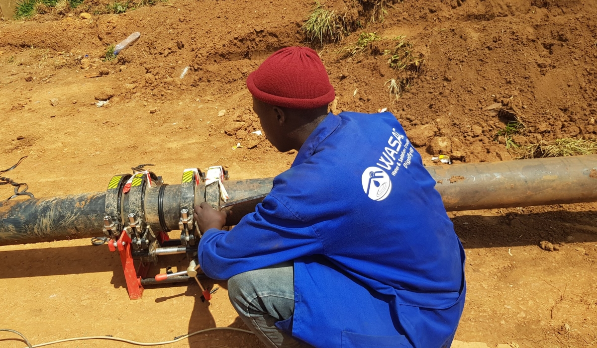 WASAC technician tries to fix a water pipe at Kanombe in Kigali. . FILE