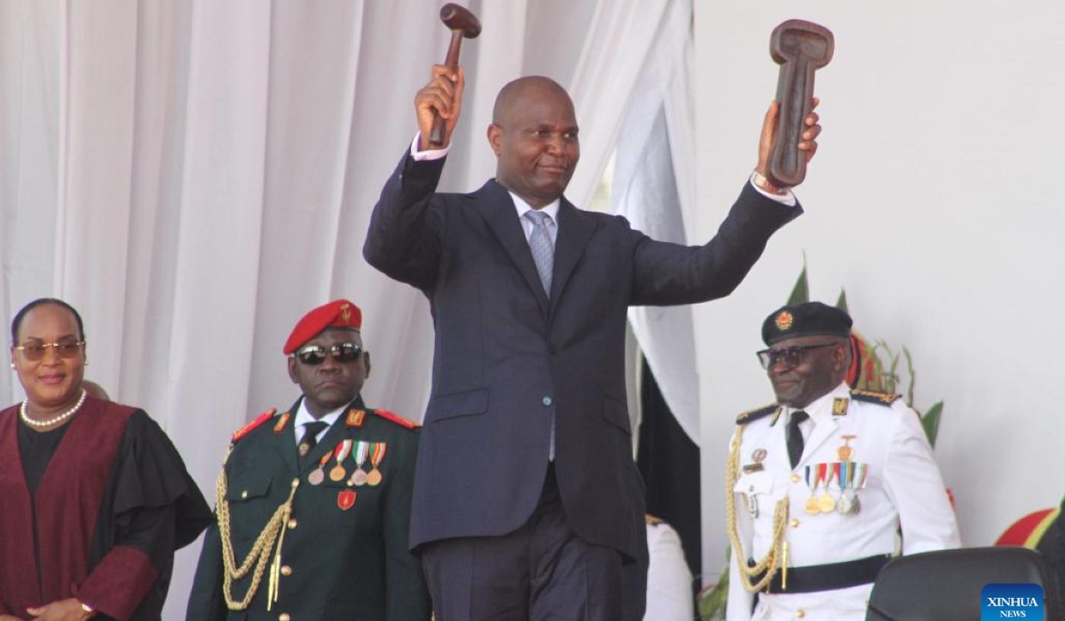 The newly sworn-in President of Mozambique Daniel Francisco Chapo demonstrates the symbol of power he received from Lucia Ribeiro, president of the Constitutional Council, during an inauguration ceremony in Maputo, Mozambique, on Jan. 15, 2025. Chapo was sworn in as the fifth president of Mozambique during a public ceremony held Wednesday in central Maputo, the capital of the southern African country. (AIM/Handout via Xinhua)