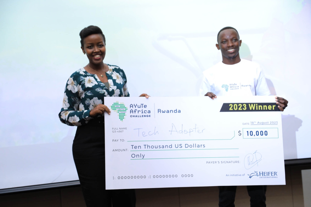 Paula Ingabire, Minister of ICT and Innovation, awards Israel Niyonshuti founder of Tech Adopter the winner of the 2023 AYUTE Africa Challenge, Rwanda, celebrating innovation in agriculture and technology.