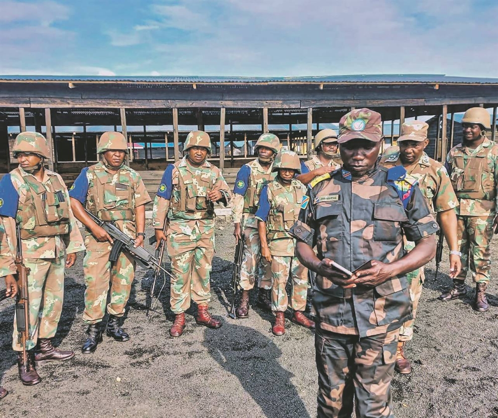 A Congolese officer speaks to South African soldiers who fight alongside the Congolese army in eastern DR Congo. Courtesy