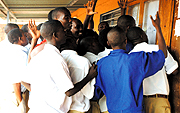 Students of ETO Muhima gather around the schoolu2019s notice board on Monday to check 2007 Senior Six results. (Photo/ G.Barya)