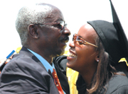 Jolly Igoma, a student of Bachelor of Business Administration in marketing who emerged  best, hugs her uncle Haruna Karimba. (Photo / G. barya)