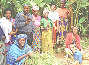 Farmers in Cyangugu pose with cassava roots.