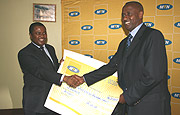 MTNu2019s CEO Themba Khumalo (L) poses with Ferwafa boss Brig. Gen Jean-Bosco Kazura after the press conference.