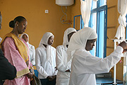 First Lady Jeannette Kagame watches as one of the students performs an experiment in the science lab. (Photo / E. Mucunguzi)