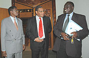 Justice Minister Tharcise Karugarama (R) talks to the Speaker of Parliament Alfred Mukezamfura (C) and Deputy Speaker Denis Polisi yesterday after Parliament amended the Constitution. (Photo/ J. Mbanda)