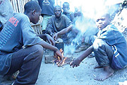 Fending for themselves: Street kids prepare food. (Photo/L. Nakayima).