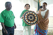 South Africau2019s Ambassador to Rwanda, Ezra Sigwela watches as Guest-of-Honour Williams-De Bruyn receives a present from Gahaya Linksu2019 Janet Nkubana during South Africau2019s Womenu2019s Day celebrations at the Embassy in Kigali (Photo/G.Barya)