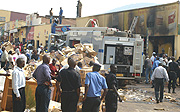 Onlookers survey the damage cause by Kigali fire. (Photo/G.Barya).