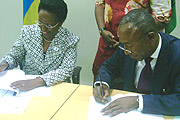 PEN TO PAPER:  Amb. Liberata Mulamula (L) and Jacob Diko Mukete sign an Administrative Agreement on behalf of the ICGLR and AfDB respectively (Photo/ E. Mukaaya)