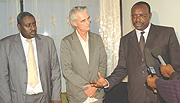 MIG Chairman Francois Kanimba (R) talks to the Press as MIG Director General Vincent Ngarambe (L) and Bart Simmons listen.