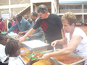 ENJOY:  Joyce Meyer (R) and husband Dave serve food to the pupils of Kingdom Education Centre at the launch of the Hand of Hope project yesterday.(Photo/ R.Mugabe)