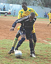 Atracou2019s defender Robert Mugabe battles for the ball with a Police player yesterday. Atraco won 2-0 to stay top of the league table (Photo/ G. Barya)    