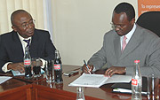 Private Sector Federation Secretary General Emmanuel Hategeka and the AFDB Resident  Representative Diko Mukete signing MoU (File photo).