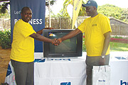 Gasore hands over a flat screen Tv to one of the the winners. (File photo)